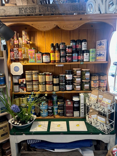 Wooden shelving with various bottles and containers on a wooden shelf.